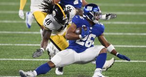 EAST RUTHERFORD, NEW JERSEY - SEPTEMBER 14: Saquon Barkley #26 of the New York Giants carries the ball as Bud Dupree #48 of the Pittsburgh Steelers defends during the first half at MetLife Stadium on September 14, 2020 in East Rutherford, New Jersey.