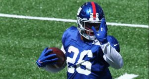 EAST RUTHERFORD, NEW JERSEY - SEPTEMBER 03: Saquon Barkley #26 of the New York Giants scores a touchdown during the Blue and White scrimmage at MetLife Stadium on September 03, 2020 in East Rutherford, New Jersey.