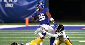 EAST RUTHERFORD, NEW JERSEY - SEPTEMBER 14: Saquon Barkley #26 of the New York Giants tries to break a tackle by Joe Haden #23 of the Pittsburgh Steelers during the second half in the game at MetLife Stadium on September 14, 2020 in East Rutherford, New Jersey.