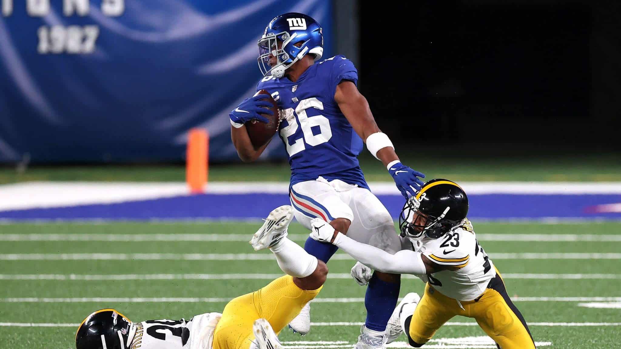 EAST RUTHERFORD, NEW JERSEY - SEPTEMBER 14: Saquon Barkley #26 of the New York Giants tries to break a tackle by Joe Haden #23 of the Pittsburgh Steelers during the second half in the game at MetLife Stadium on September 14, 2020 in East Rutherford, New Jersey.