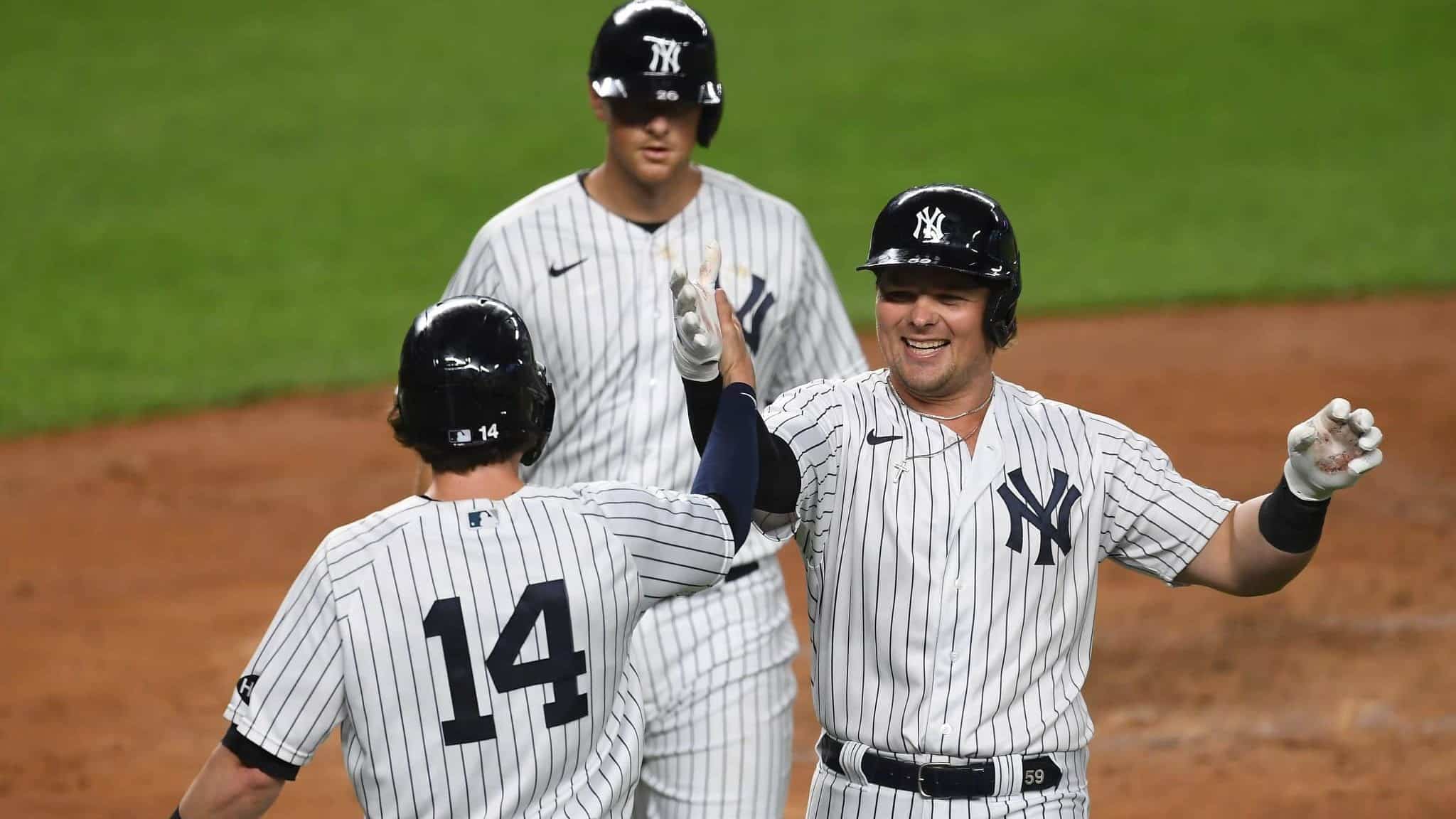 NEW YORK, NEW YORK - SEPTEMBER 15: Luke Voit #59 of the New York Yankees celebrates with Tyler Wade #14 after hitting a three-run home run during the second inning against the Toronto Blue Jays at Yankee Stadium on September 15, 2020 in the Bronx borough of New York City.