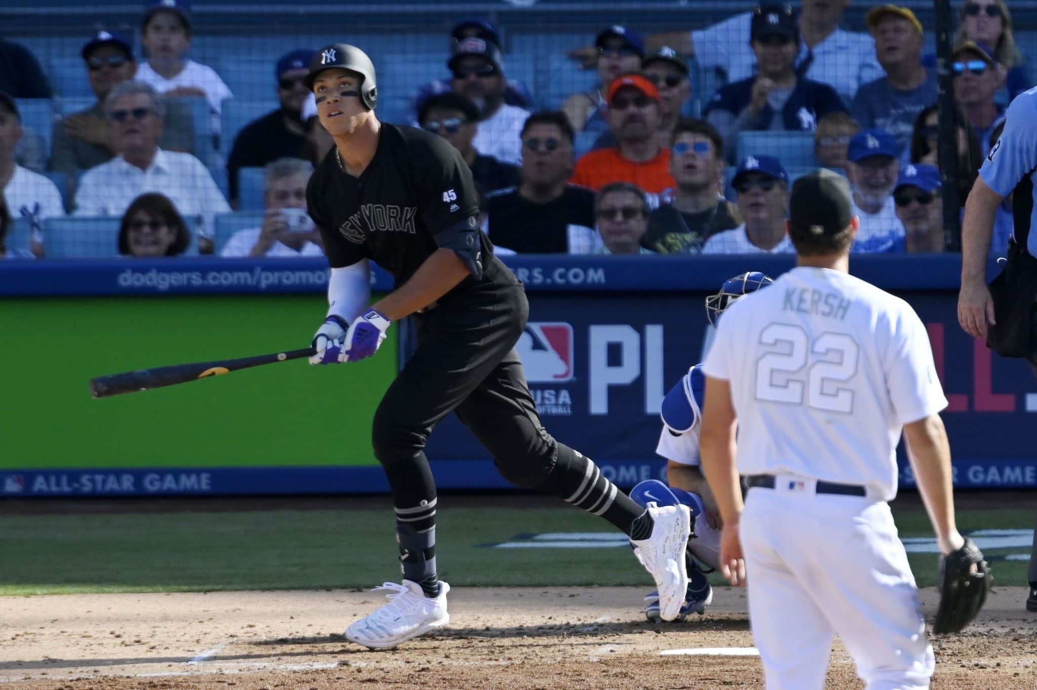 New York Yankees' Aaron Judge, left, runs to first as he hits a solo home run as Los Angeles Dodgers starting pitcher Clayton Kershaw watches during the third inning of a baseball game Sunday, Aug. 25, 2019, in Los Angeles.